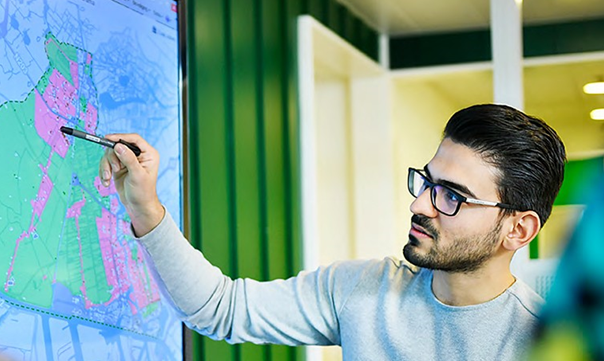 Medewerker gemeente wijst wijk aan op kaart